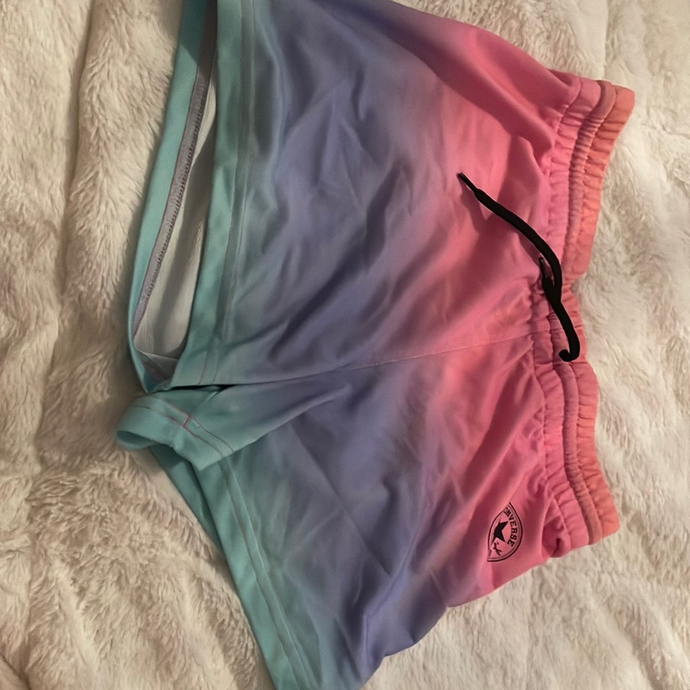 The brand is converse, the size kids XL, and the color are pink purple and blue.
